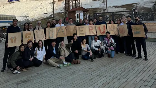 Diaverum Kazakhstan Employees holding handmade Diaverum sign.
